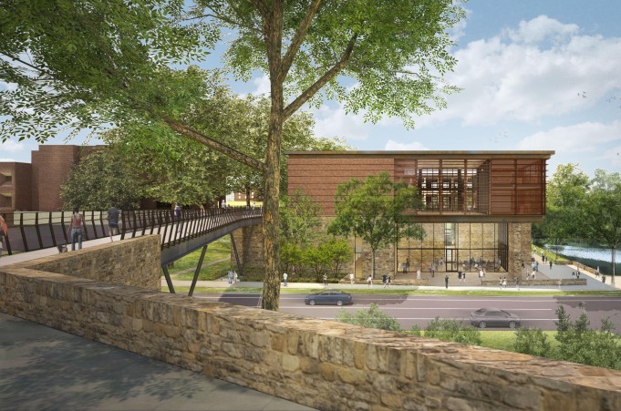 Architectural rendering of a modern building with extensive use of glass and wood, featuring a pedestrian bridge leading to its entrance. The building is surrounded by lush greenery, a body of water, and has people walking around, indicating a lively atmosphere