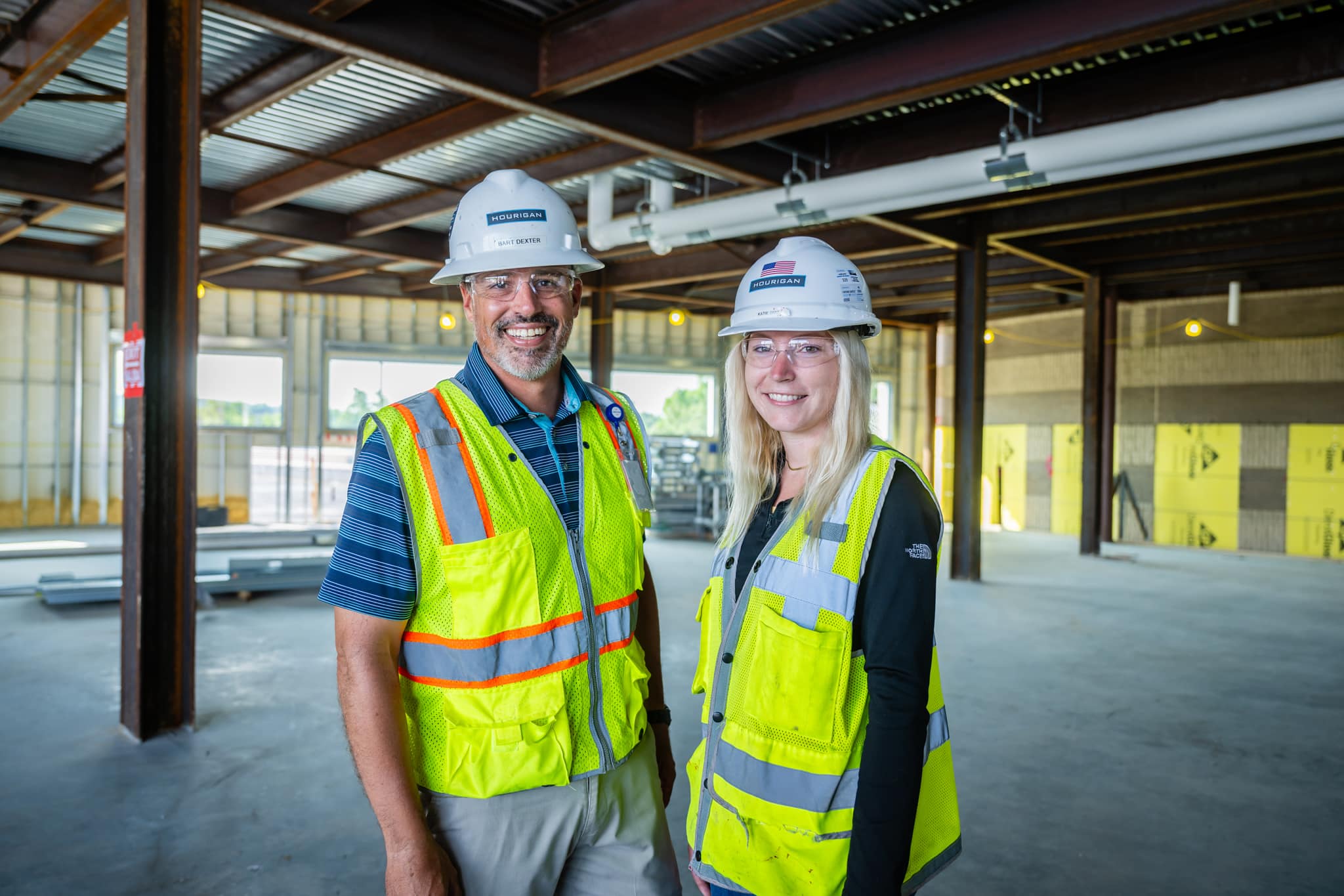 Women and man in construction safety gear on a construction site