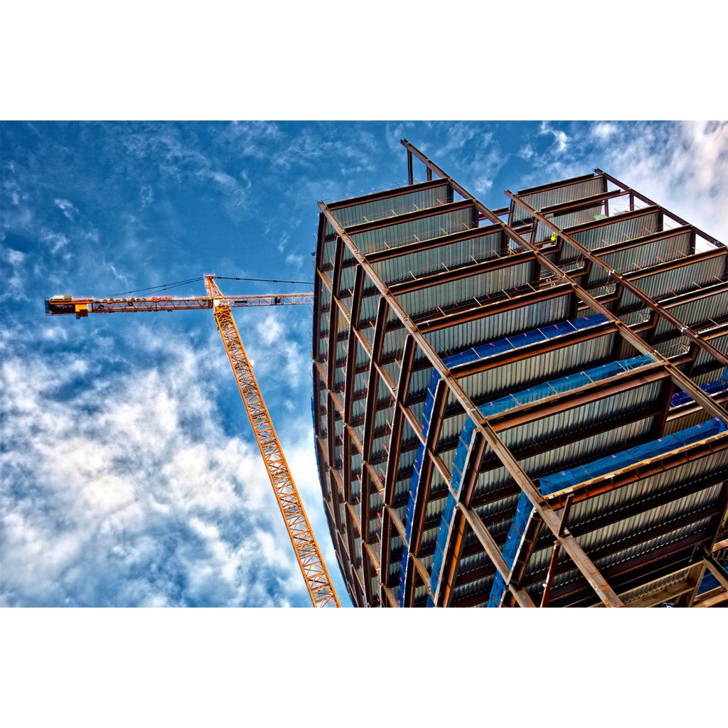 Worms eye view of crane and skyscraper under construction